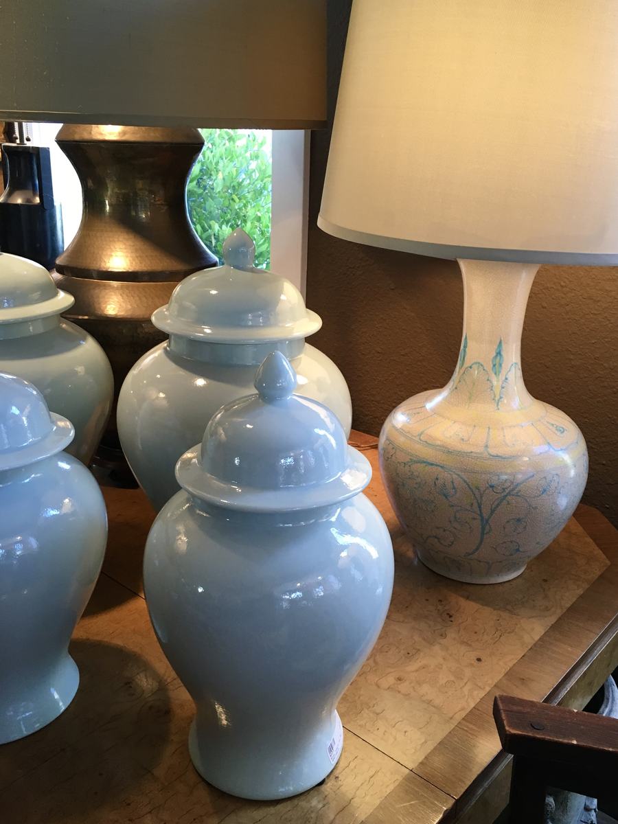 Celadon ginger jars beside a crackle-glaze table lamp.