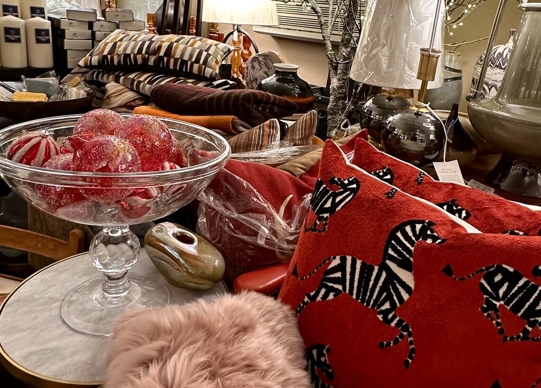 Red zebra-motif pillows, blown glass ornaments and striped cushions.